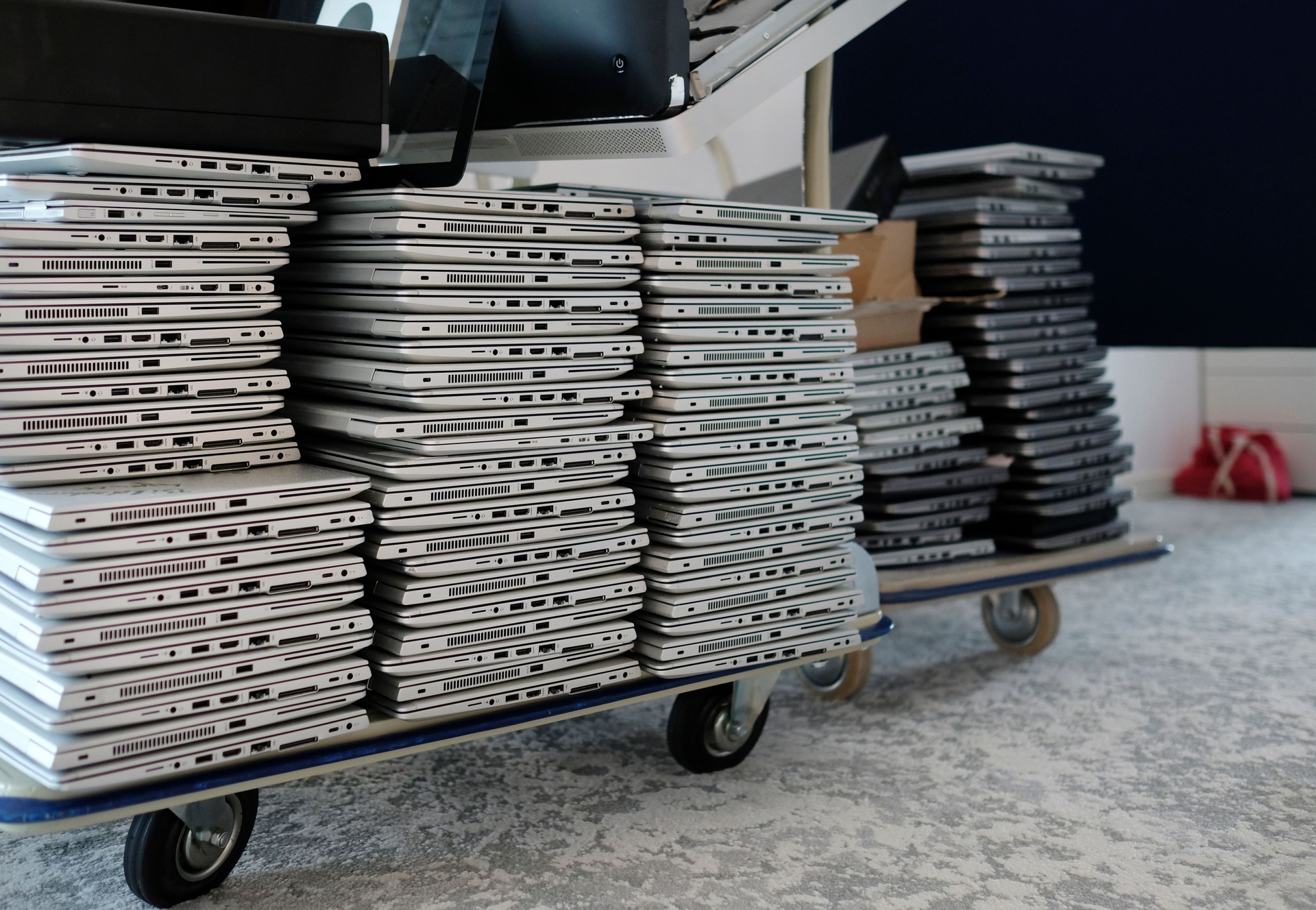 Stack of laptops in the storage room of a company